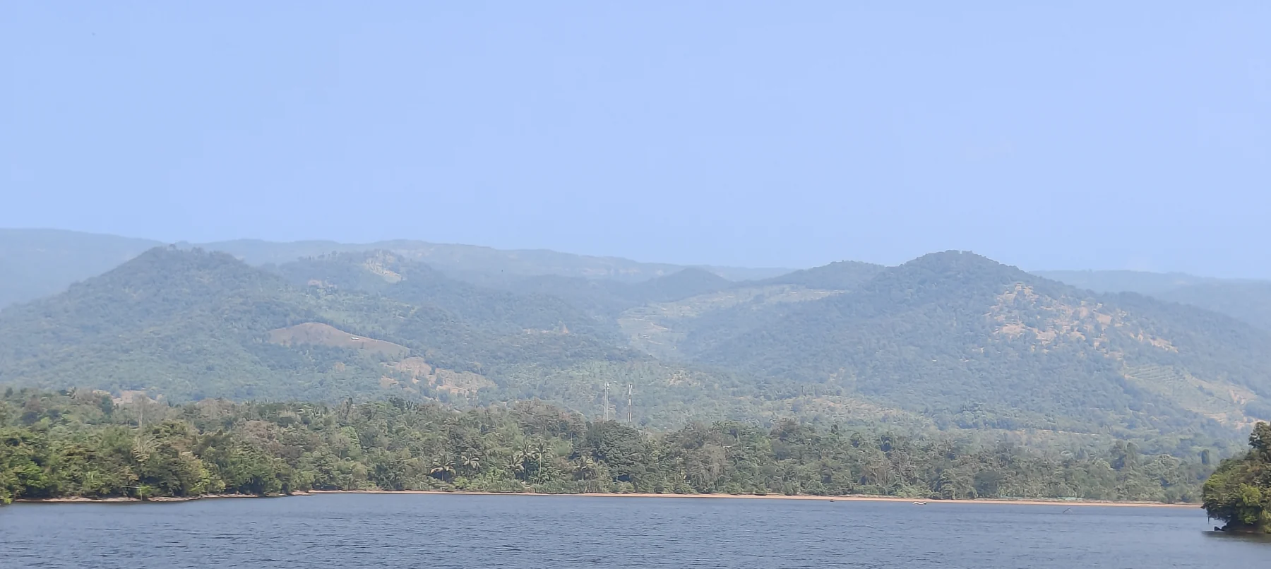 Forested hills and water in the Tillari region, not estate water access